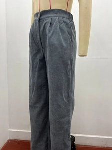 Detail of high waist corduroy pants showing elastic waistband and button closure