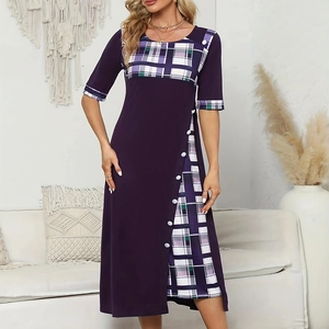 Detail view of purple midi dress with plaid patchwork hem and white decorative buttons