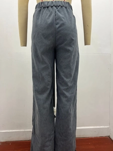 Detail of high waisted corduroy trousers showing elastic waistband and ribbed fabric texture