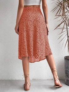 Rear view of a floral split midi skirt in brick red with a high-waisted A-line silhouette