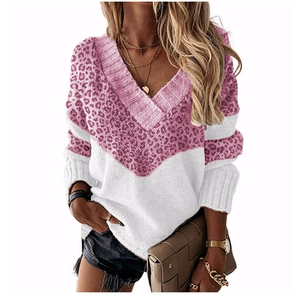 Close-up of V-neck sweater with pink and leopard print color block and ribbed cuffs