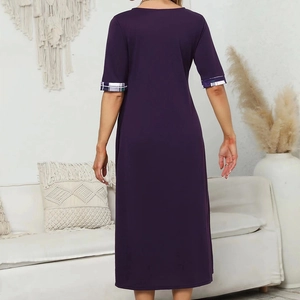 Rear view of deep purple midi dress with plaid cuffs in a minimalist home setting