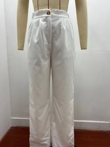 Detail view of high-waist corduroy pants with elastic waistband and amber button