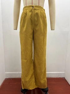 Detail of high-waist corduroy pants with elastic waistband and vertical stripe texture