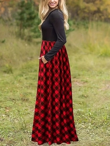Détail d'une robe à manches longues avec corsage noir et jupe à carreaux rouge et noir