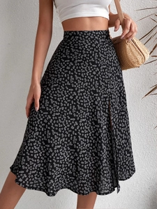 Detail view of a floral split midi skirt with a high-waisted A-line cut in black and white