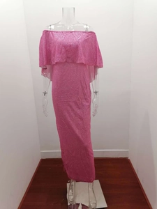 Detail of glitter pink fabric and off-shoulder neckline on evening gown dress