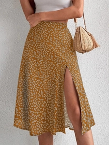 Detail of floral midi skirt with side slit and mustard yellow chiffon fabric