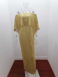 Detail of shimmering gold metallic evening dress with layered ruffle off-shoulder design
