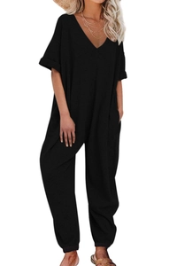 Detail of loose fit black V-neck jumpsuit with short sleeves and elastic cinched ankles