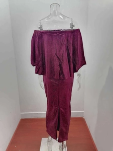 Detailed close-up of dark burgundy glitter fabric on an off-shoulder evening dress