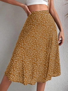 Detail of high waisted floral midi skirt featuring white daisies on vintage ginger fabric