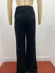 Rear view of high waist corduroy trousers showing elastic waistband and ribbed texture