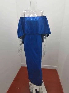 Detail of royal blue sequin dress featuring ruffles and off-shoulder split evening style