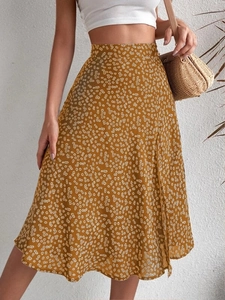 Detailed texture of ginger yellow floral chiffon midi skirt with side slit and daisy print