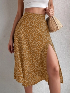 Detail view of mustard yellow floral midi skirt with high slit and elegant side drape
