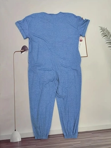 Close-up of sky blue short sleeve jumpsuit showing soft knit texture and elastic cuffs