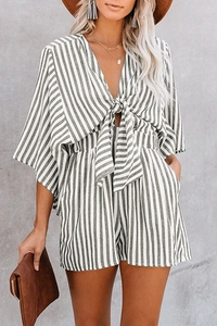 Detailed close-up of striped romper showing deep V-neckline and decorative front tie knot