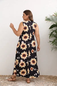Rear view of a sleeveless maxi dress with sunflower prints on black fabric