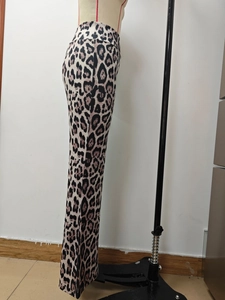 Detailed side view of high-waisted leopard print flare trousers on a mannequin