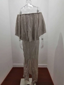 Rear view of champagne silver sparkling dress featuring tiered ruffles and back slit detail
