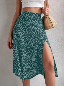 Detail of high waist floral midi skirt featuring a side slit and daisy print pattern