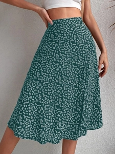Detail of A-line floral skirt in dark green featuring high waist and side slit design