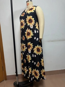 Detailed fabric shot of plus size sleeveless maxi dress with vibrant sunflower print pattern
