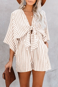 Detail of summer striped romper featuring a deep V-neckline and front waist tie design