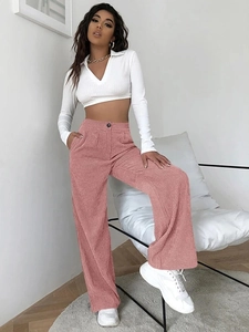 Detailed texture of pink corduroy wide-leg pants with high waist and side pockets