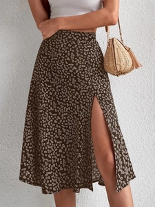 Floral midi skirt detail showing the high waist and stylish side slit on dark fabric