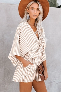 Detail of the deep V-neck and flared sleeves on a striped cotton-linen summer romper