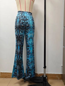 Detail of high waisted flared pants with blue mandala print and bohemian style fabric