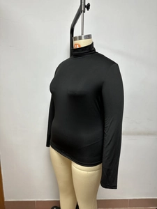 Close-up of the black turtleneck long-sleeve top showing smooth knit fabric and slim fit