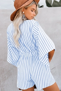 Close-up of the elastic waist detail and back cut of a blue striped summer romper