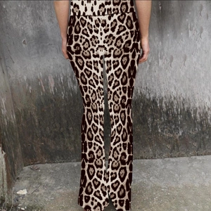 Detailed back view of high-waisted leopard print flare pants with slim-fit design