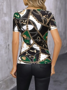 Detail of baroque pattern with gold chains and tassels on the back of slim fit T-shirt