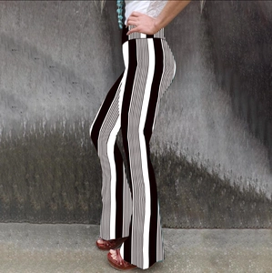 Detailed side view of high-waisted flared trousers with bold black and white vertical stripes