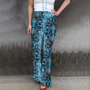 Detail of high waist flared pants with blue tie-dye and white mandala floral pattern