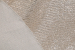 Detailed macro view of sparkling silver fabric with mesh texture and neat stitching
