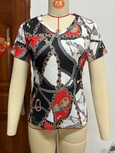Detail shot of V-neck short sleeve T-shirt featuring vintage chain and tassel 3D prints