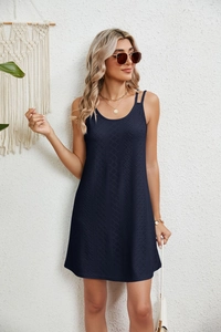 Detail of navy blue sleeveless dress with intricate hollow-out embroidery texture