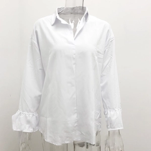 Detail of white long sleeve blouse featuring lapel V-neck and ruffled flare cuffs