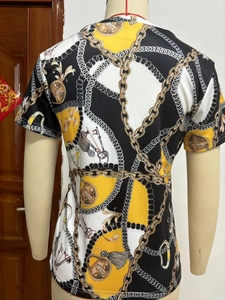 Detailed back view of T-shirt showing baroque print with gold chains and vintage key patterns