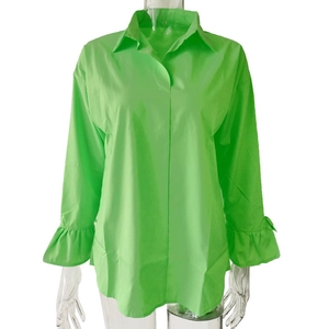Detail of light green blouse featuring lapel collar and ruffle flare cuffs on mannequin