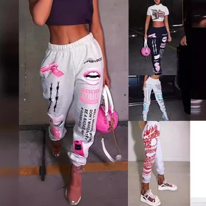 Detailed close-up of high-waist joggers with pink gun and street style graphic prints