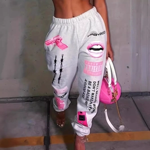 Detail of grey joggers featuring drawstring waist and pink graphic street style prints