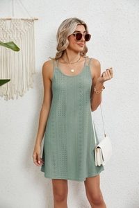 Detail of light green mini dress featuring delicate eyelet embroidery and thin straps