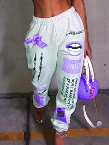 Detail of streetwear sweatpants with purple graphic prints and a comfortable elastic waist