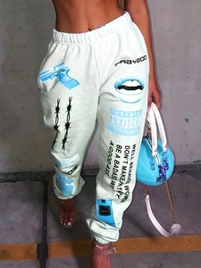 Close-up of printed jogger pants with blue street art patterns and ankle cuffs